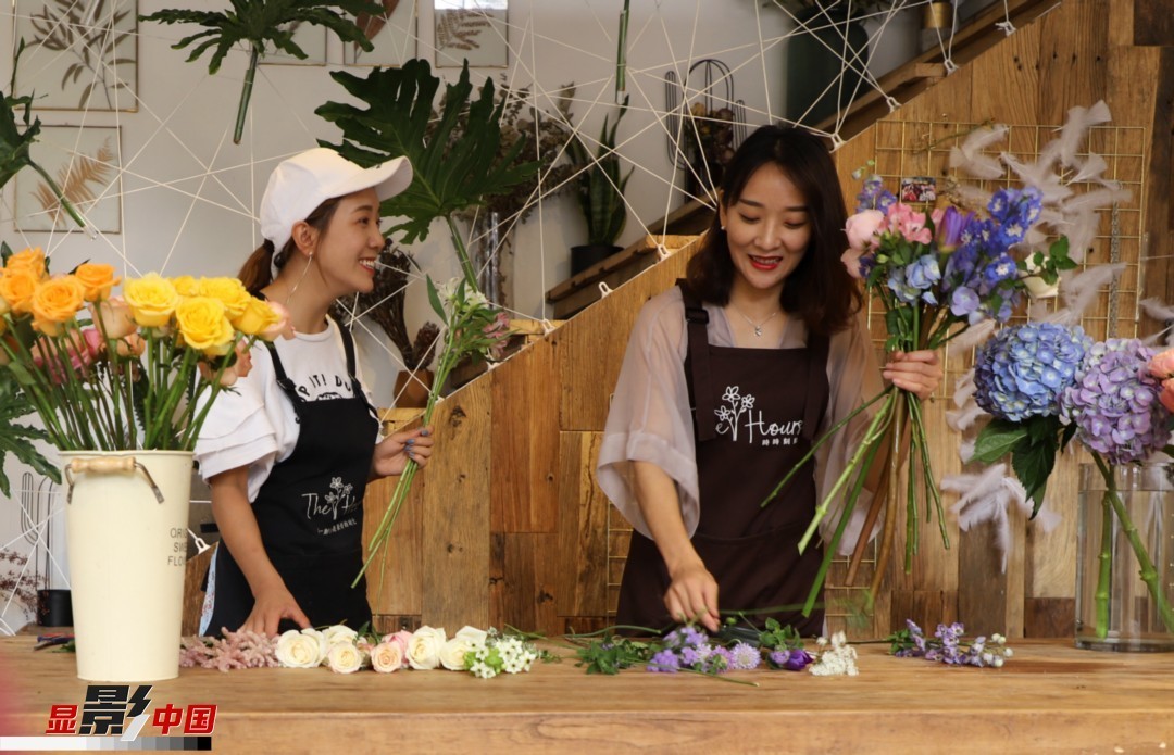 “昆明是鮮花的原產(chǎn)地，有亞洲最大的鮮切花交易市場，可以說具備開花店的天時地利；另外和很多女孩一樣，我從小也就有開花店的夢想！”說起當(dāng)初的決定，王黎媛說一是因為夢想，另外也跟昆明這個城市產(chǎn)花、賣花的“基因”有關(guān)。圖為王黎媛和同事在制作花束。新華網(wǎng) 周亞平/攝 念新洪/文
